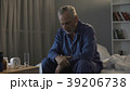 Depressed senior person sitting in bed and Depressed senior person sitting in bed and 39206738