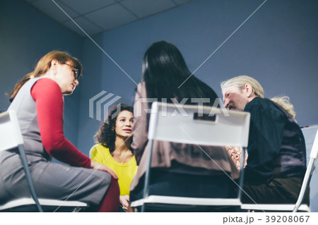 Group therapy session sitting in a circle 39208067