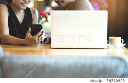 woman holding show phone screen to couple 39210990