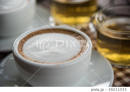 Coffee in cup on table with tea at coffee shop 39211555