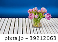 Purple tulips in the glass vase on the white 39212063