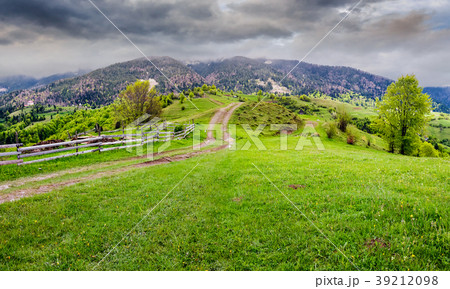 country road through rural area in mountains 39212098
