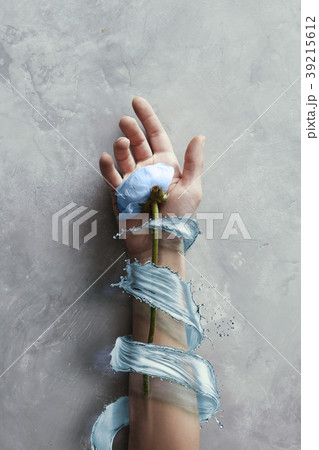 Hands with flowers with splash blue water in stone Hands with flowers with splash blue water in stone 39215612