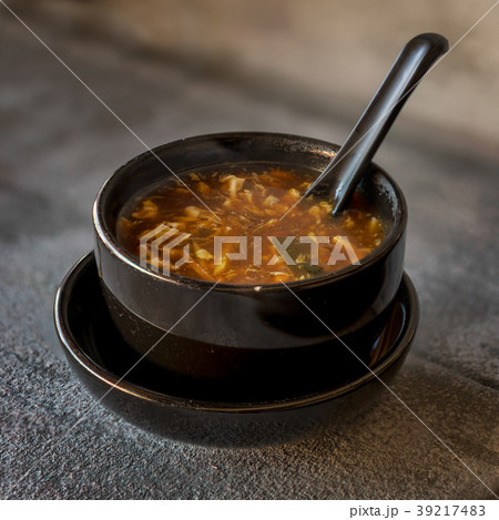 sour soup on black iron plate 39217483