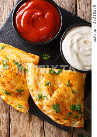 Italian closed pizza calzone with sauces Italian closed pizza calzone with sauces 39218259