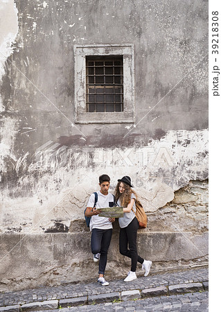 Two young tourists with a map in the old town. 39218308