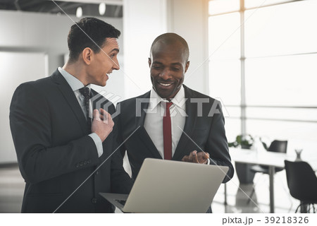 Two men in formal wear discussing working moments Two men in formal wear discussing working moments 39218326