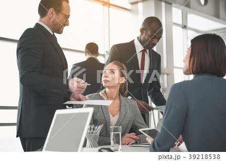 Business partners discussing documents at meeting Business partners discussing documents at meeting 39218538