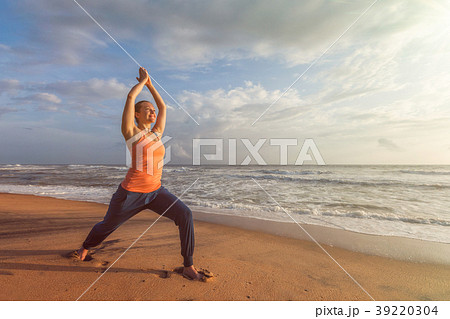 Woman doing yoga asana Virabhadrasana 1 Warrior 39220304