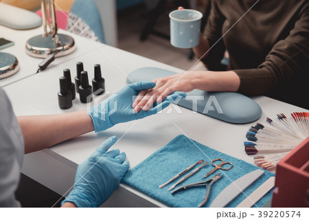 Manicurist arm creating nail correction Manicurist arm creating nail correction 39220574