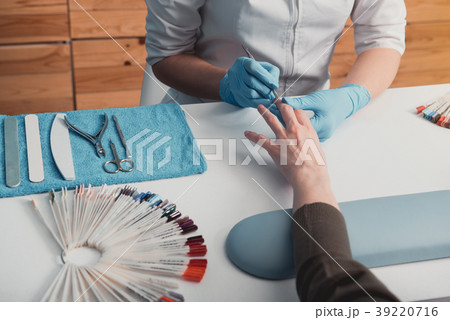 Female arm keeping care about nails 39220716