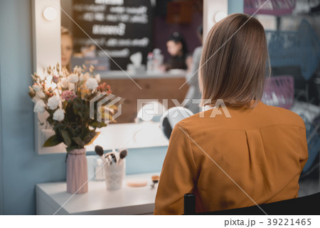 Woman watching at reflection indoor Woman watching at reflection indoor 39221465
