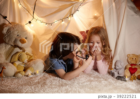 Joyful children playing in toy tent Joyful children playing in toy tent 39222521