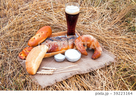 Glass of beer or kvass and breads on tablecloth Glass of beer or kvass and breads on tablecloth 39223164