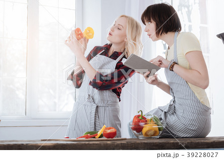 Pleasant young woman reading a recipe 39228027