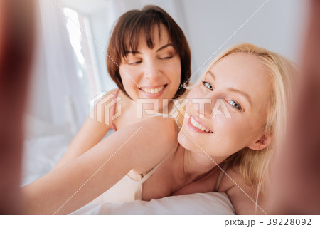 Beautiful blonde woman holding the camera Beautiful blonde woman holding the camera 39228092