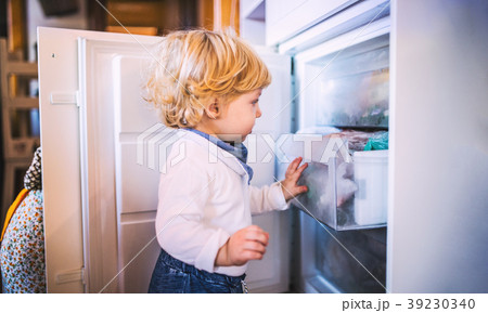 Toddler boy in dangerous situation at home. Child 39230340