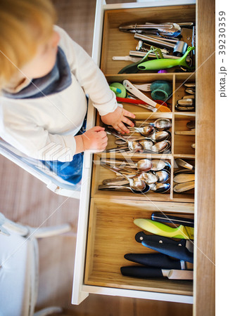 Toddler boy in dangerous situation at home. Child 39230359