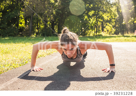 Young fit woman exercising by doing push-ups 39231228