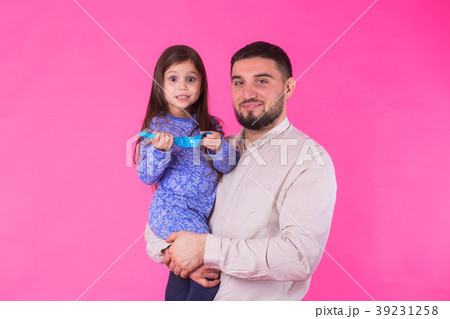 Happy father holding baby daughter in hands over Happy father holding baby daughter in hands over 39231258
