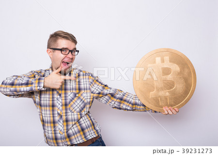 Happy business man holding big golden bitcoin on 39231273