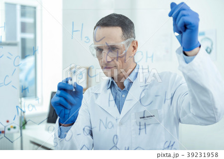 Concentrated experienced researcher writing Concentrated experienced researcher writing 39231958