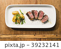 beef and potatoes on white plate with silverware 39232141