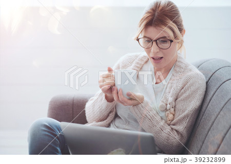 Positive attractive woman holding a cup of tea 39232899
