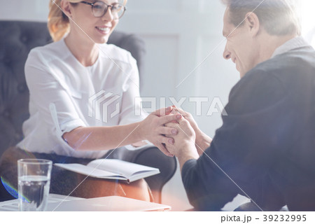 Pleasant sympathetic psychologist holding the Pleasant sympathetic psychologist holding the 39232995
