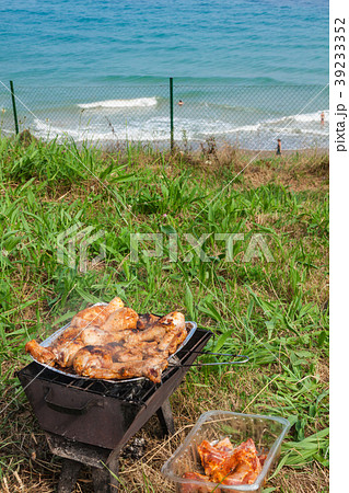 Grilled chicken thighs on the flaming grill. 39233352