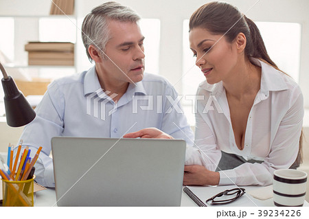 Pleasant young woman sitting with her colleague 39234226