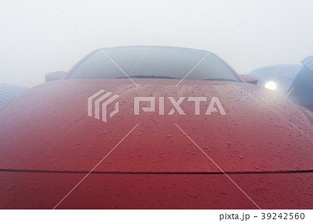 Dew drops on the red car after morning. Dew drops on the red car after morning. 39242560