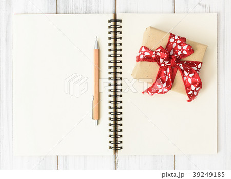 Notebook,brown pencil and red gift box on  wood  39249185