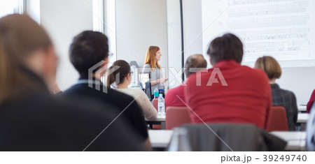 Woman giving presentation in lecture hall at 39249740