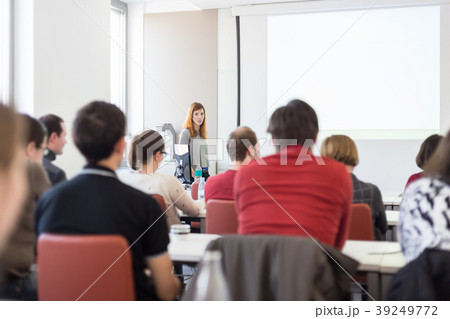 Woman giving presentation in lecture hall at 39249772