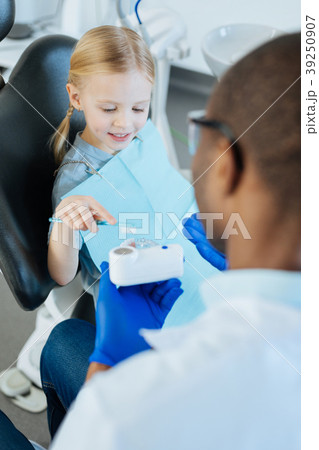 Little girl practicing correct teeth brushing in 39250907