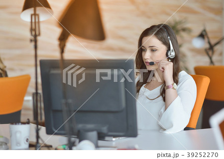 Attractive woman listening to music while working Attractive woman listening to music while working 39252270