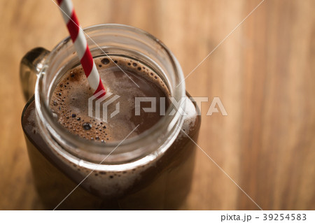 warm cocoa in jar mug on a wooden table 39254583