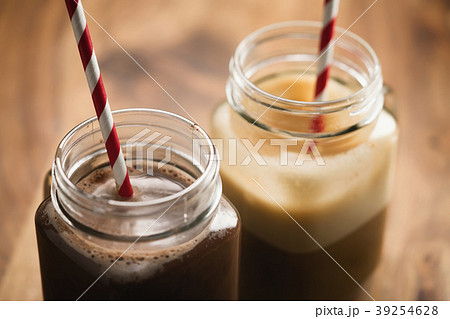 warm cocoa and coffee in jar mugs on a wooden 39254628