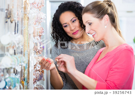 Two friends in jewelry department of shopping mall 39256743