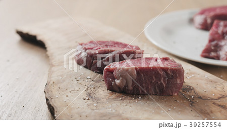 seasoned raw beef fillet for steak on wooden board seasoned raw beef fillet for steak on wooden board 39257554