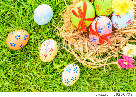 Closeup Colorful Easter eggs on green grass field Closeup Colorful Easter eggs on green grass field 39260708