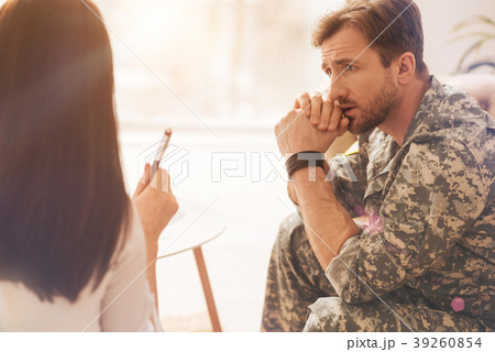 Sad military man wrinkling his forehead Sad military man wrinkling his forehead 39260854