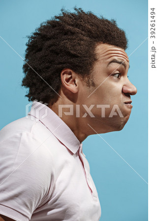 The young emotional angry man screaming on blue 39261494