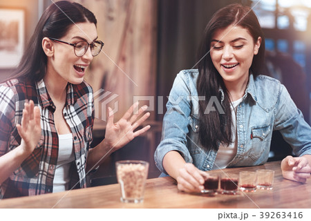 Delighted young woman drinking Delighted young woman drinking 39263416