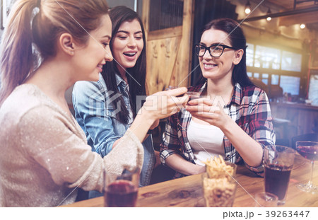 Positive pretty women drinking to their friendship 39263447