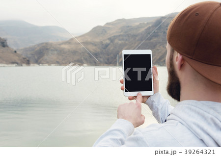 Close-up of a hipster in a brown cap in the open 39264321