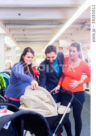 Woman, man, and sales lady in baby store 39265011