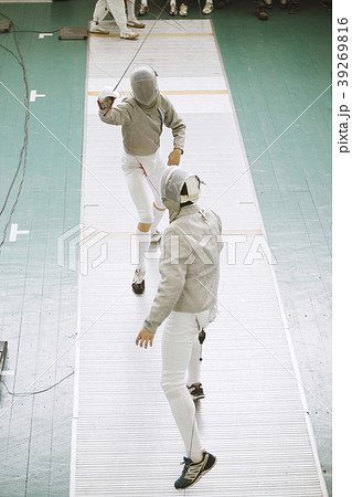 Young fencers in protective costumes with rapiers Young fencers in protective costumes with rapiers 39269816