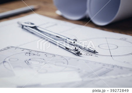 Rolls of blueprints, drawing compass and graphical 39272849